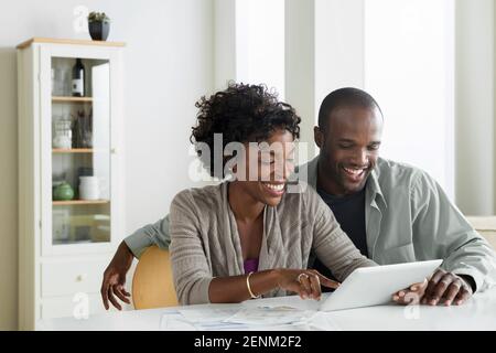 Mid adult couple using digital tablet Stock Photo