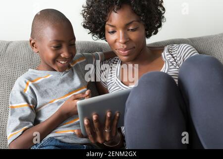 Mother and son using digital tablet Stock Photo