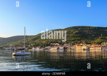 Vis, Croatia - October 2, 2011: View of a Sailboat with Vis Island in the Background Stock Photo