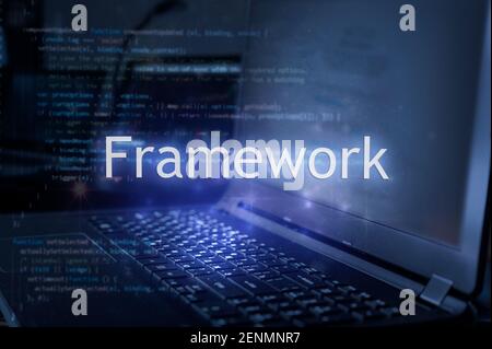 Framework inscription against laptop and code background. Technology concept. Stock Photo