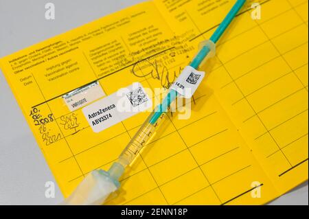 GERMANY, Hamburg, corona pandemic, largest vaccination center in Germany, injection syringe and vaccination pass with sticker of vaccine AstraZeneca against SARS CoV 2 or Covid-19 Stock Photo