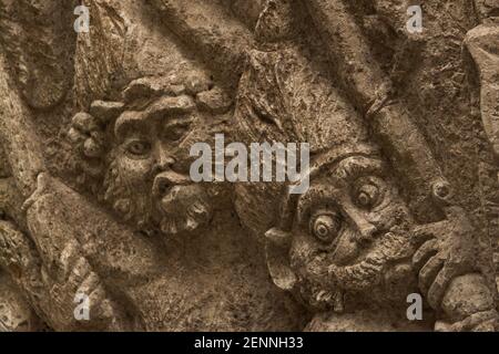 Ancient Hindu figures carved on a wall in Ubud, Bali Stock Photo