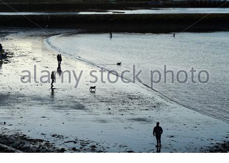 Edinburgh, Scotland, UK. 26th Feb 2021. People silhouetted at Granton harbour and Wardie Bay on a cold and sunny late afternoon.  Credit: Craig Brown/Alamy Live News Stock Photo