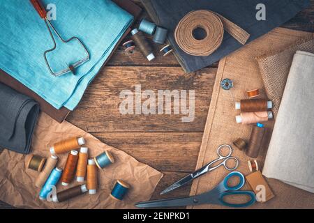 A set of sewing accessories on a wooden background with space to copy. Stock Photo