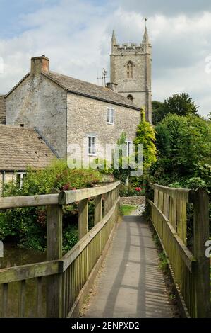 A wooden bridge leading to the church in the village of Nunney Catch, Somerset, UK. Stock Photo