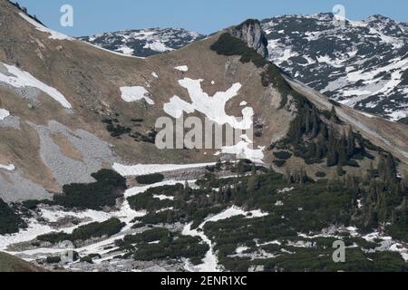 Early spring up on Loser mountain with melting snow and rock formations  on a sunny day, Altaussee, Loser, Salzkammergut, Austria Stock Photo