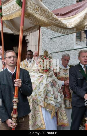 Corpus Christi procession in Hallstatt with men in festive costume and priest carrying the monstrance, Hallstatt, Austria Stock Photo