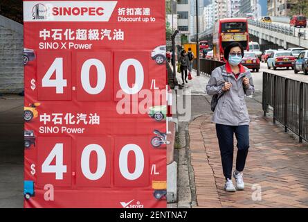 A pedestrian walks past the Chinese oil and gas enterprise China Petroleum & Chemical Corporation, known as Sinopec, gas station seen in Hong Kong. Stock Photo