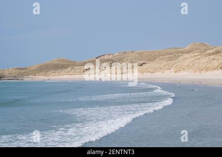 Clear blue water lapping on the shores of the north coast of Scotland Stock Photo