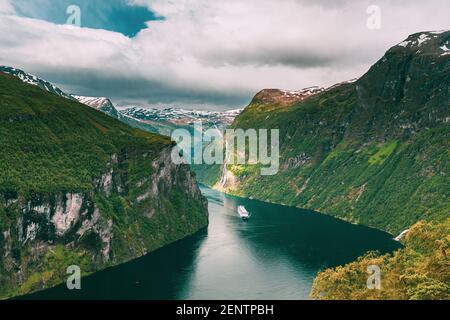 Geirangerfjord, Norway. Touristic Ship Ferry Boat Cruise Ship Liner Floating Near Geiranger In Geirangerfjorden In Summer Day. Famous Norwegian Stock Photo