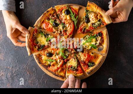 Freshly baked pizza with cheese and tomatoes. Top view. Stock Photo