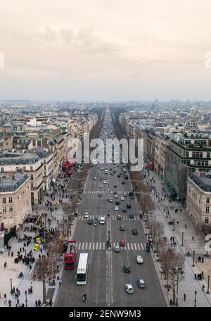 Skyline of Paris city in france with people and cars on the Champs Elysees avenue from the top of Arc de Triomphe monument. Stock Photo