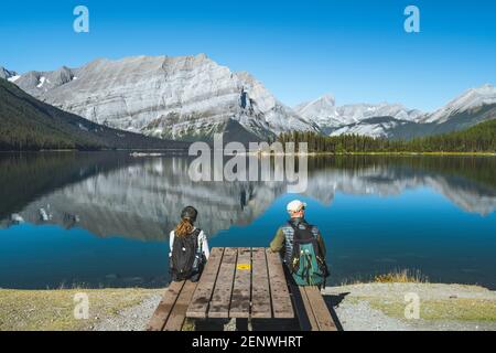 Hikers enjoying the view at Upper Kananaskis Lake during summer, Kananaskis Country, Alberta, Canada.