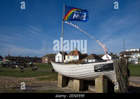 NHS Thank You Rainbow Flag and small boat situated on Lancing seafront in England. Stock Photo