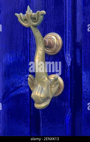 Traditional brass carp-shaped Maltese door knocker in Valletta, Malta Stock Photo