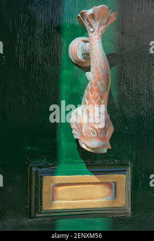 Traditional brass carp-shaped Maltese door knocker and letter box in Valletta, Malta Stock Photo