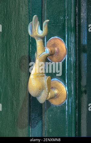 Traditional brass dolphin-shaped Maltese door knocker in Valletta, Malta Stock Photo