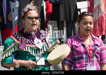 Canadian First Nations choir: Ethnic Indians teen girls with national drums sing in traditional costumes. The ceremony takes place as Toronto celebrat Stock Photo