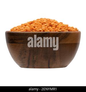 Red lentil in wooden bowl. Isolated on the white background Stock Photo