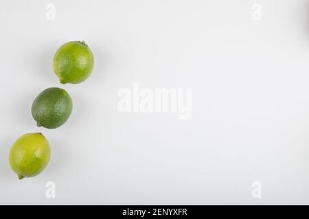 Three ripe lime fruits isolated on white background Stock Photo