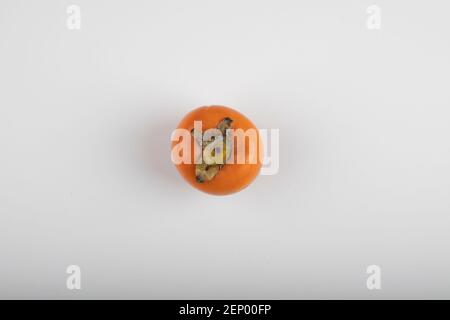 Single persimmon kaki fruit isolated on white background Stock Photo