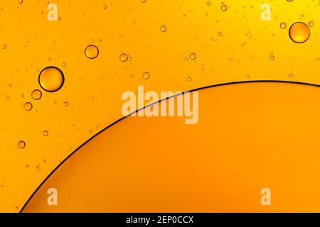 Golden bubbles. Yellow circles. Abstract background. Bubble oil on water. Macro-photography. Stock Photo