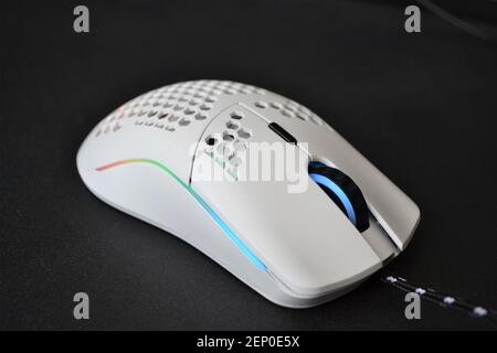 White backlit gaming mouse on the black table Stock Photo