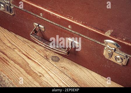 Old suitcase on wooden background. Stock Photo