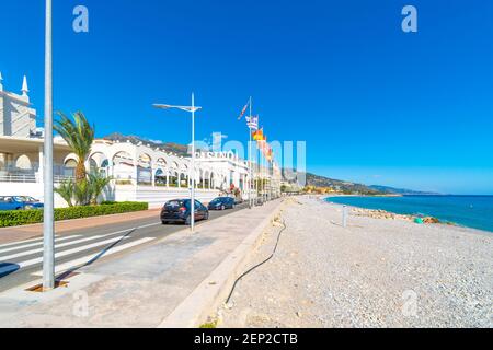 General view of the Casino Barrière flags and sign along the coast of the French Riviera at Menton, France