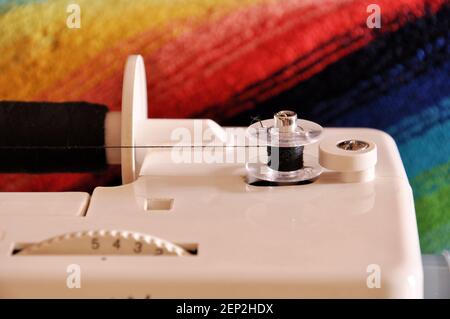 Device for winding thread on a bobbin on an electric sewing machine Stock Photo