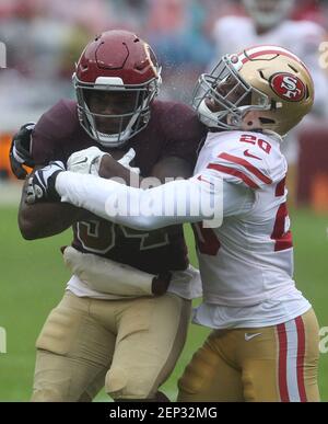 Washington Redskins RB Wendell Smallwood (34) is tackled by San Francisco  49ers DB Jimmie Ward (20) in the second quarter of a game at FedEx Field in  Landover, Maryland on October 20