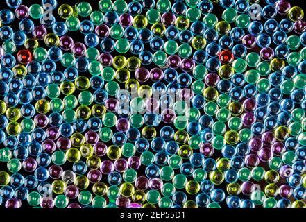 Multicolored glass pebbles as a background. Fishbowl beads. Stock Photo