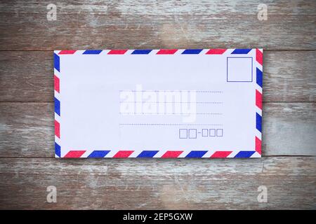 Top view with air mail envelope on the wood table in office work place Stock Photo