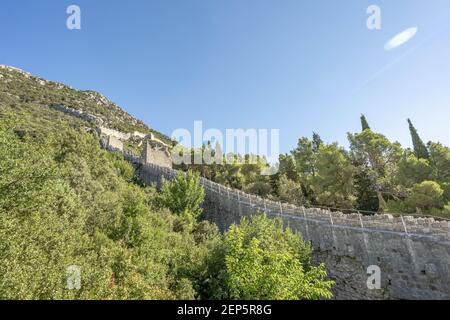 Narrow stone passage stairs on Wall of Ston aong hills in Croatia summer sunny morning Stock Photo