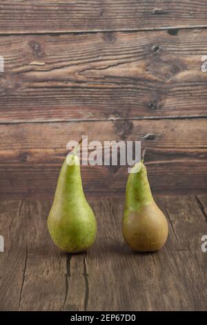 Two tasty fresh pears placed on wooden surface Stock Photo
