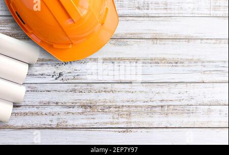 rolls of blueprints and yellow helmet Stock Photo - Alamy