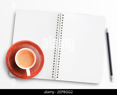 Top view of modern workplace with notebooks or notepad,pencil and cup of coffee on white table background. Flat lay design concept.Office desk table w Stock Photo