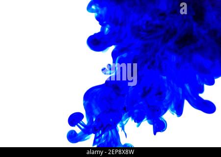 blue ink in water on white background. Blue abstract paint on a