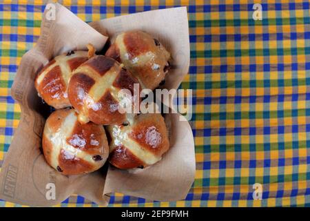 Five hot cross buns in a basket for Easter. Stock Photo