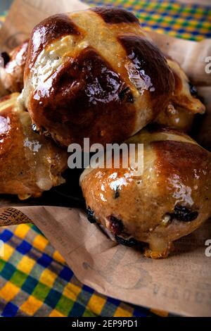 Five hot cross buns in a basket for Easter. Stock Photo