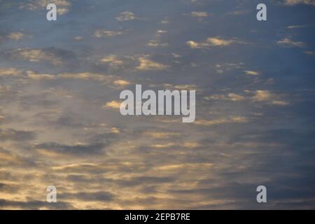 Background pastel sky texture with several little clouds at sunrise Stock Photo