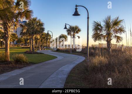 Myrtle Beach South Carolina Sunrise. Sunrise along the palmetto lined boardwalk on the Atlantic Coast in downtown Myrtle Beach. Stock Photo