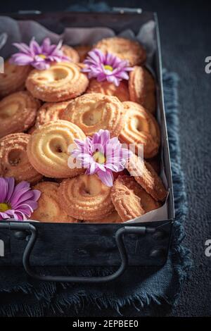 Delicious danish cookies in an ceramic plate on dark table Stock Photo