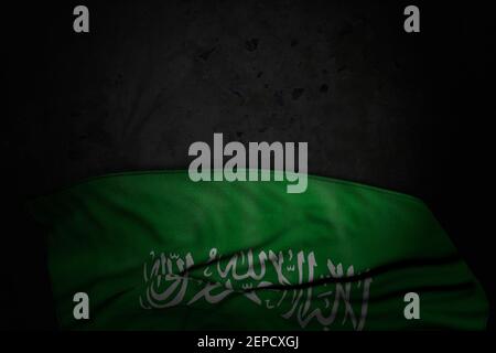 pretty dark picture of Saudi Arabia flag with big folds on black stone with free space for your text - any celebration flag 3d illustration Stock Photo