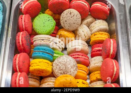 colorful macaroons close up at bakery market. sweet cakes assortment. Stock Photo