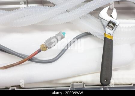 installing new air conditioner system at apartments or office rooms. conditioner with tools close up. Stock Photo