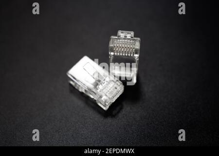 lan and internet rj45 cable connector at black matte background Stock Photo