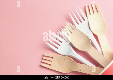 wooden and plastic forks at paper and plastic cup. eco-friendly and disposable with plastic recycling concept. plastic waste concept Stock Photo