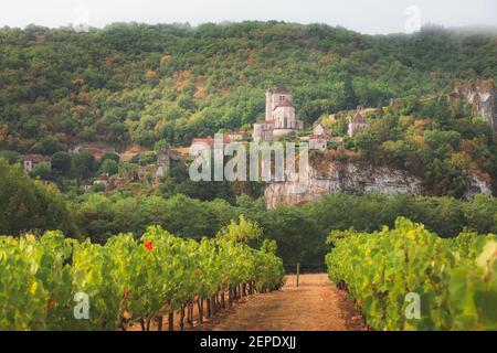 Vineyard countryside view of the French medieval hilltop village Saint-Cirq-Lapopie in the Lot Valley of southwest France. Stock Photo