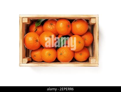 Sweet ripe orange tangerines in a wooden crate isolated on white background. Fresh citrus in wood box. Eco-friendly rustic style containers for fruits Stock Photo